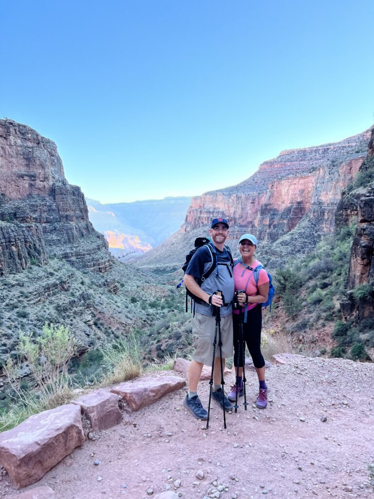 couple standing in front of the grand canyon